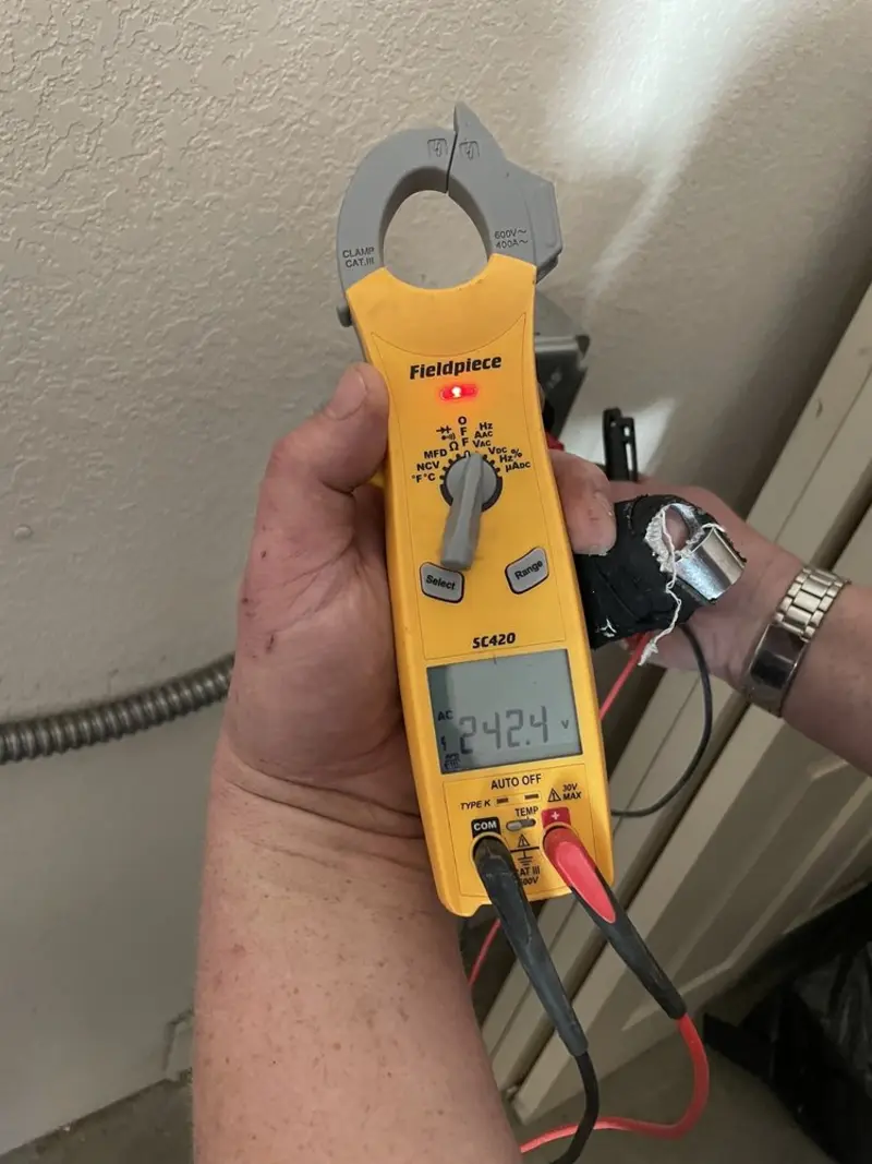 Voltage testing with clamp meter during Outlet Installation in Foster